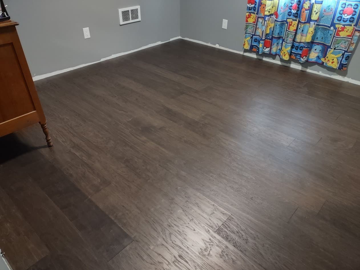Wide view of the completed hardwood floor running through the bedroom