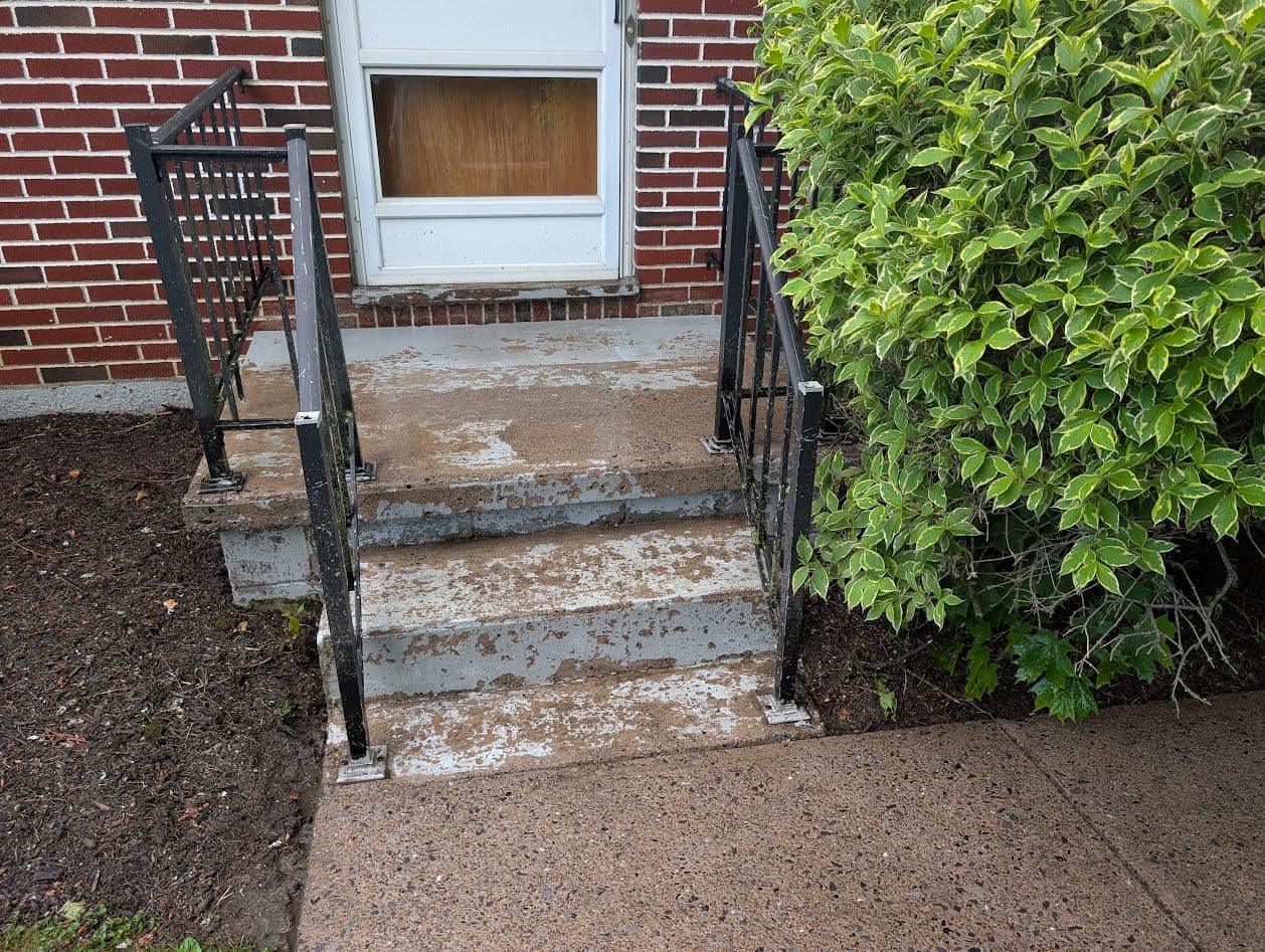 The stoop and steps after pressure-washing, cleaned down and stripped of the old failing paint and ready to prime