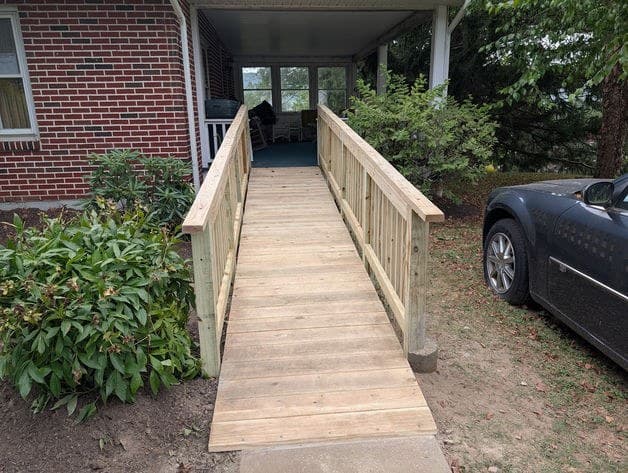 The bare-wood ramp running the length of the home to the entrance