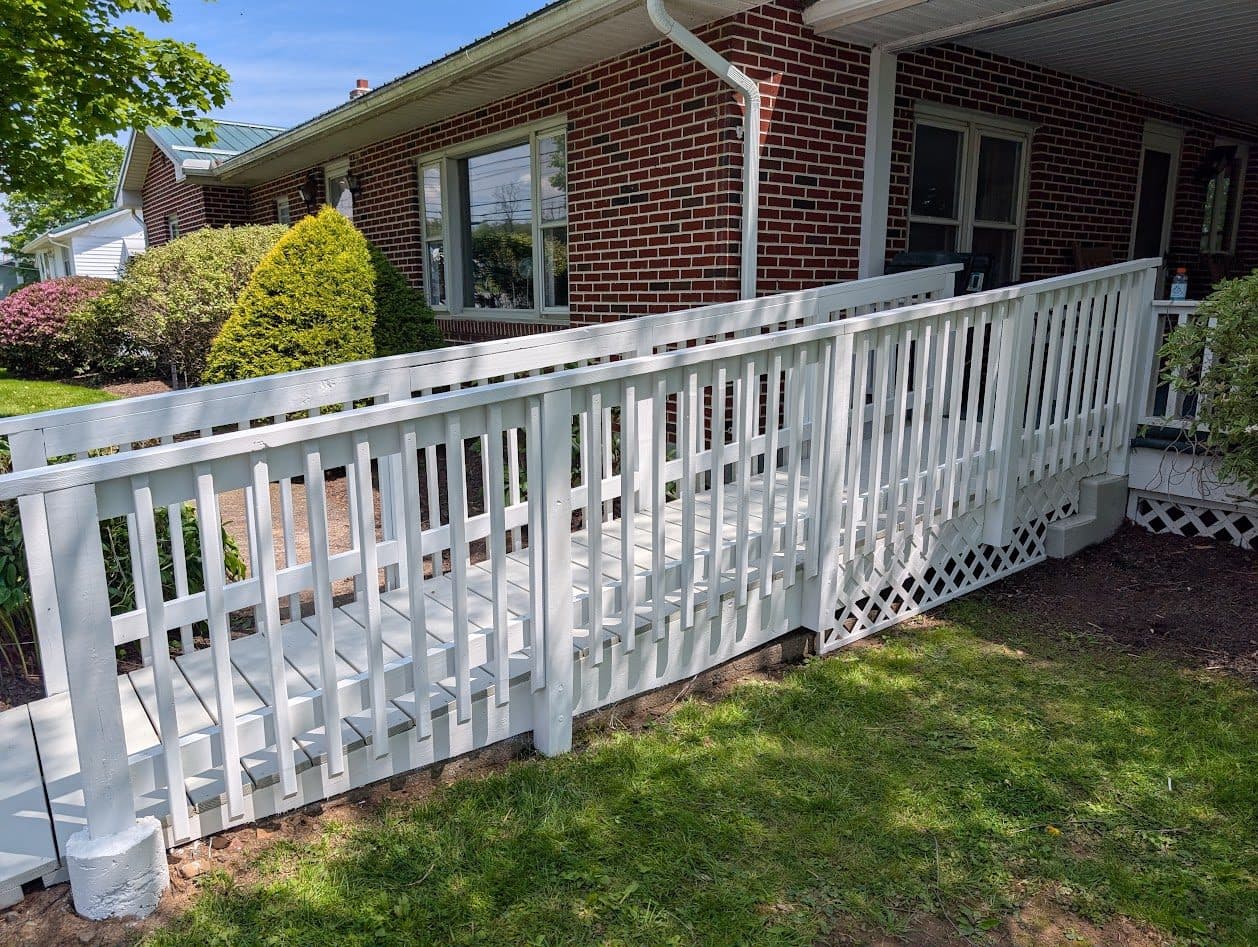The accessibility ramp painted white, viewed from the side
