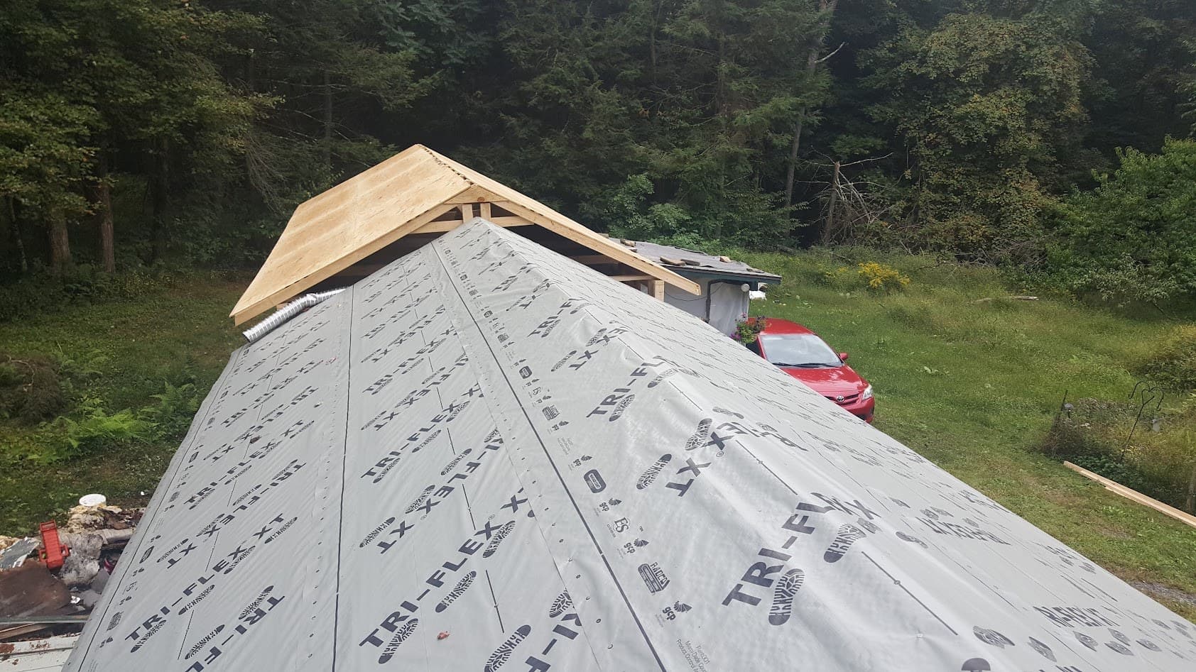 Tri-Flex synthetic underlayment wrapping the new roof deck before the metal roofing