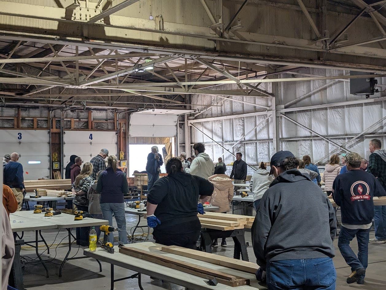 Community volunteers working the bed-build stations during the public build
